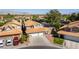 Two-story home with three-car garage, well-manicured lawn, and orange roof tiles at 8436 Kawala Dr, Las Vegas, NV 89128