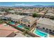 A bird's eye view of a neighborhood showcasing homes with pools and well-maintained yards at 8448 Cambria Cellars Ct, Las Vegas, NV 89139