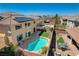 Aerial view of a backyard oasis with a pool, patio, artificial grass and outdoor seating area at 8448 Cambria Cellars Ct, Las Vegas, NV 89139