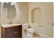 Half bathroom featuring a vanity, toilet, decorative mirror, and tile floors at 8448 Cambria Cellars Ct, Las Vegas, NV 89139