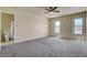 Bright bedroom showcasing two windows, neutral carpet, and an attached bathroom at 8448 Cambria Cellars Ct, Las Vegas, NV 89139