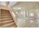 Inviting entryway with staircase, neutral decor, and tile flooring that complements the open floor plan and bright atmosphere at 8448 Cambria Cellars Ct, Las Vegas, NV 89139
