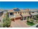 A beautiful home featuring solar panels, a three car garage and classic landscaping at 8448 Cambria Cellars Ct, Las Vegas, NV 89139