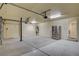 Spacious garage with epoxy flooring, stainless steel refrigerator, and an automatic door opener at 8448 Cambria Cellars Ct, Las Vegas, NV 89139