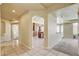 Hallway leading to a kitchen with rich cabinetry, stainless steel appliances, and modern finishes throughout at 8448 Cambria Cellars Ct, Las Vegas, NV 89139