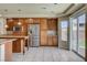 Bright eat-in kitchen with stainless steel appliances, island, and sliding door access to yard at 8448 Cambria Cellars Ct, Las Vegas, NV 89139