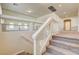 Upstairs landing features clear glass railings and carpeting, offering a bright and airy transition between levels at 8448 Cambria Cellars Ct, Las Vegas, NV 89139