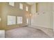 Sun-filled living room featuring tall ceilings, ample windows, and neutral-toned carpet and tile floors for modern appeal at 8448 Cambria Cellars Ct, Las Vegas, NV 89139