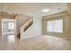 Open living room with tile flooring, staircase, and large windows offering abundant natural light at 8448 Cambria Cellars Ct, Las Vegas, NV 89139