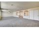 Spacious living room featuring neutral carpet, paint, and stylish architectural columns defining the adjacent space at 8448 Cambria Cellars Ct, Las Vegas, NV 89139