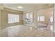 Spacious living area featuring tile flooring, an open layout, and views into the adjacent living spaces at 8448 Cambria Cellars Ct, Las Vegas, NV 89139