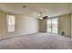 Bright and spacious living room with carpet, window, and sliding glass doors to backyard at 8448 Cambria Cellars Ct, Las Vegas, NV 89139