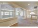 Spacious living room with decorative columns, neutral carpet, and abundant natural light, creates an inviting and airy atmosphere at 8448 Cambria Cellars Ct, Las Vegas, NV 89139