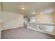 Spacious loft with neutral carpet, clear glass railings, and ample natural light provides versatile living or recreation space at 8448 Cambria Cellars Ct, Las Vegas, NV 89139