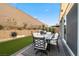 Inviting backyard patio featuring an outdoor dining set, ideal for entertaining or enjoying a quiet meal outdoors at 8705 Fordster St, Las Vegas, NV 89166