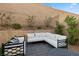 Cozy backyard seating area with stylish black and white cushions, perfect for relaxing and enjoying the outdoor space at 8705 Fordster St, Las Vegas, NV 89166