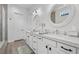Modern bathroom showcasing dual sinks, sleek white cabinets, and stylish fixtures at 8705 Fordster St, Las Vegas, NV 89166