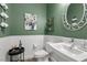 Stylish bathroom featuring neutral green walls, a vanity with a vessel sink, and wainscoting at 8705 Fordster St, Las Vegas, NV 89166