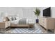 Virtual staging of a modern bedroom showcasing a bed, stylish furniture, and decor at 8705 Fordster St, Las Vegas, NV 89166