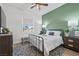 Bright bedroom featuring wood floors, a patterned rug, modern ceiling fan, and a neutral color palette at 8705 Fordster St, Las Vegas, NV 89166