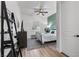 Bright bedroom featuring wood floors, a patterned rug, modern ceiling fan, and a neutral color palette at 8705 Fordster St, Las Vegas, NV 89166