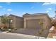 Charming home with a two-car garage, brick-paved driveway, and manicured landscaping at 8705 Fordster St, Las Vegas, NV 89166