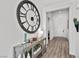 Bright hallway with modern decor, stylish console table, and decorative clock, offering a welcoming ambiance at 8705 Fordster St, Las Vegas, NV 89166