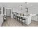 Bright kitchen with white cabinets, a large island, and modern pendant lighting at 8705 Fordster St, Las Vegas, NV 89166