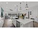 Open concept kitchen island overlooking living room and stainless steel dishwasher at 8705 Fordster St, Las Vegas, NV 89166