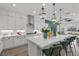 Open kitchen with an island, modern pendant lights, and views into the living room at 8705 Fordster St, Las Vegas, NV 89166