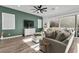 Comfortable living room with contemporary decor, a green accent wall, and sliding glass doors to the backyard at 8705 Fordster St, Las Vegas, NV 89166