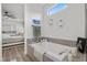 Relaxing main bath with modern tub, coordinated decor, and adjacent views to the main bedroom at 8705 Fordster St, Las Vegas, NV 89166