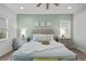Serene main bedroom featuring a tufted headboard, green walls, and soft, natural lighting at 8705 Fordster St, Las Vegas, NV 89166