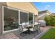 Outdoor dining on the patio visible from inside through sliding glass door, seamlessly blending indoor and outdoor living at 8705 Fordster St, Las Vegas, NV 89166