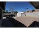 Backyard featuring gravel groundcover, shed, trailer, and block wall fencing at 878 Samoy St, Las Vegas, NV 89110