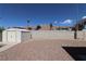 Backyard featuring gravel groundcover, block wall fencing, and storage shed at 878 Samoy St, Las Vegas, NV 89110