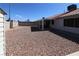 View of backyard with rock ground cover, patio, and fencing at 878 Samoy St, Las Vegas, NV 89110