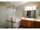 Bathroom featuring a large soaking tub, walk-in shower, and double sink vanity at 878 Samoy St, Las Vegas, NV 89110