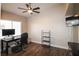 Bedroom with wood floors, ceiling fan, and large windows providing natural light at 878 Samoy St, Las Vegas, NV 89110