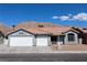 Charming single-story home featuring a three-car garage, desert landscaping and mountain views at 878 Samoy St, Las Vegas, NV 89110