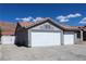 Spacious three-car garage featuring white doors and concrete driveway at 878 Samoy St, Las Vegas, NV 89110