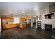 Open-concept kitchen with stainless steel appliances, center island, fireplace, and dark wood floors at 878 Samoy St, Las Vegas, NV 89110