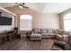 Comfortable living room features a sectional sofa, a large window, and hardwood floors at 878 Samoy St, Las Vegas, NV 89110