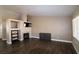 Spacious living room with a fireplace and stylish dark wood floors at 878 Samoy St, Las Vegas, NV 89110