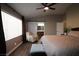 Cozy bedroom features a large window, hardwood floors, a sliding barn door, and neutral colors at 878 Samoy St, Las Vegas, NV 89110