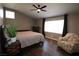 Spacious main bedroom featuring wood floors, ceiling fan, sitting area, and large windows at 878 Samoy St, Las Vegas, NV 89110