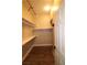 Walk-in closet featuring built-in shelving and wood floors at 878 Samoy St, Las Vegas, NV 89110