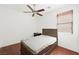 Cozy bedroom featuring a ceiling fan and wood floors at 9104 Ashiwi Ave, Las Vegas, NV 89178