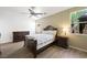 Comfortable bedroom with natural light, ceiling fan, and stylish furniture, offering a relaxing space to unwind at 9104 Ashiwi Ave, Las Vegas, NV 89178
