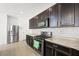 Modern kitchen featuring stainless steel appliances, granite countertops, and ample cabinet space for storage and organization at 9104 Ashiwi Ave, Las Vegas, NV 89178
